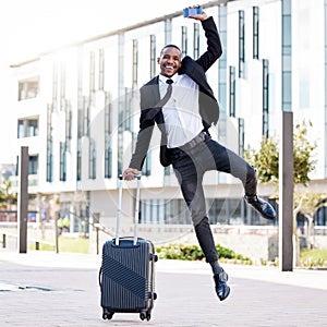 I couldnt ask for more. a young businessman jumping for joy while holding his smartphone.