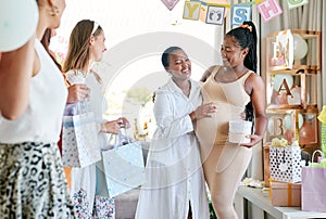 I couldnt be happier. a pregnant mother to be receiving gifts from her friends at her baby shower.