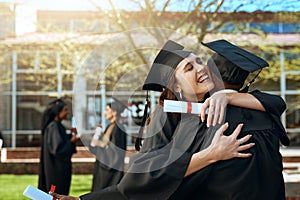 I couldnt imagine sharing this experience with anyone else. a happy young man and woman hugging on graduation day.