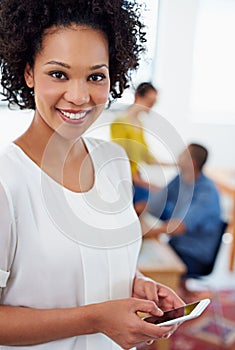 I couldnt live without my technology. Closeup portrait of a businesswoman with her phone and office staff in the