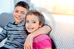 I am definelty my sisters keeper. Portrait of two adorable young siblings posing with their arms around each other while