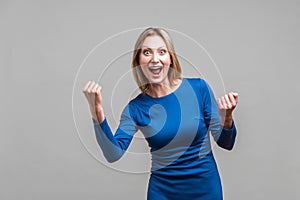 I did it! Portrait of satisfied successful woman celebrating achievement. indoor studio shot isolated on gray background