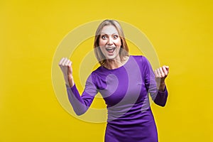 I did it! Portrait of satisfied successful woman celebrating achievement. indoor studio shot isolated on yellow background