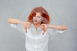 I dislike. Closeup portrait of unhappy angry mad pissed off redhead curly woman annoyed wife giving thumbs down gesture looking