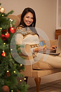I do all my Christmas shopping online. Portrait of an attractive young woman doing her Christmas shopping online.