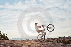 I do it for the thrill of it. a young man out mountain biking during the day.