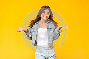 I don`t know. Portrait of confused beautiful brunette young woman with makeup in denim casual style standing with raised arms and