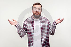 I don`t know what to say! Portrait of doubtful bearded man shrugging shoulders making helpless gesture. isolated on white