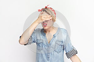 I don& x27;t want to see. Shocked scared blonde woman standing covering eyes with palm.