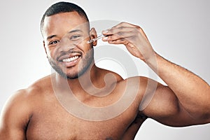 I dont mind adding extra steps to my skincare routine. Studio portrait of a handsome young man applying serum to his