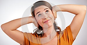 I dont wanna hear it. Studio shot of a young woman closing her ears with her hands against a white background.