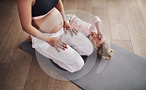 I dont want to do yoga anymore. an adorable little girl and her mother at home.