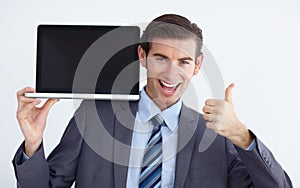 I endorse this. A young businessman endorsing a laptop with a thumbs up. photo