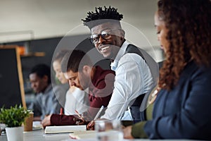 I feel so fulfilled to be a part of the team. Portrait of a young businessman working alongside his colleagues in an