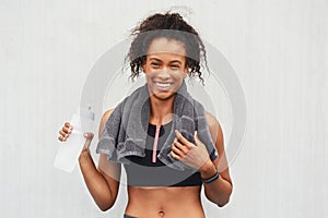 I always feel great after a workout. Cropped portrait of an attractive young female athlete drinking water against a