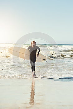 I got some pretty cool waves out there. a handsome young man at the beach with his surfboard.