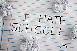 I Hate School. Phrase I Hate School on notebook sheet with some