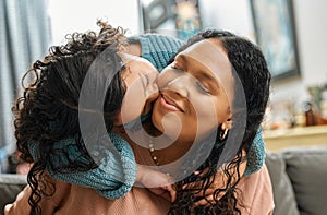 I have the best mom in the whole world. Shot of an adorable little girl giving her mother kiss while bonding with her in