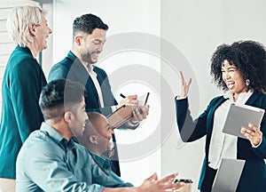 I have great news. a diverse group of businesspeople celebrating a success during a meeting in the office.