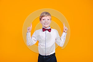 I have idea. Child boy with fingers up on yellow background