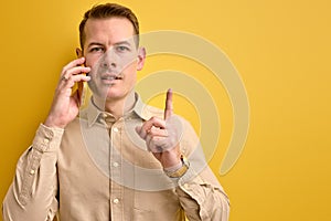 I have idea. Man sharing ideas with business partner while talking on phone