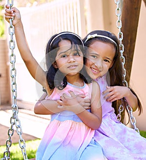 I have a playmate for life. Shot of two little girls sitting together on swing.