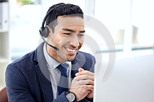 I have some good news... a customer service agent wearing a headset while sitting at his desk.