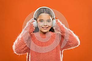 I have a soul for music. Cute girl child listening to music in stereo headphones. Small child enjoy music playing in