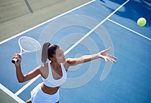 I have to make a decision. an attractive young woman playing tennis outside.