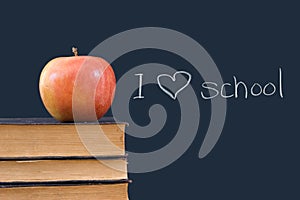 I 'heart' school written on blackboard with apple,