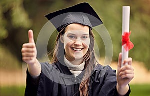 I hope you get the results you want. Portrait of a young woman showing thumbs up on graduation day.
