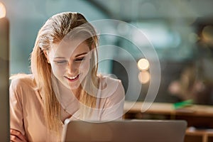 I impress myself sometimes. a smiling young businesswoman working on a laptop in an office.