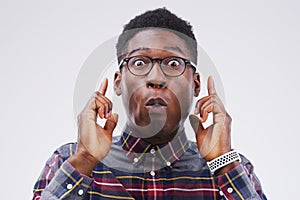 I just thought of the perfect idea. Studio shot of a young man making a funny face against a gray background.