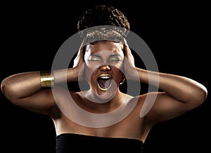 I just want to let it all out. an attractive and elegantly dressed young woman screaming against a dark background.