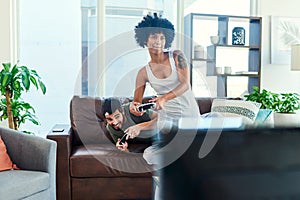 I know how to win this game. a young couple having fun while playing video games at home.