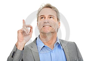 I like what i see. Studio shot of a happy businessman pointing upwards.