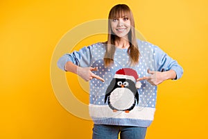 I`ll take part in ugly sweater party event concept. Photo of cheerful teen lady demonstrating pattern with comic cute