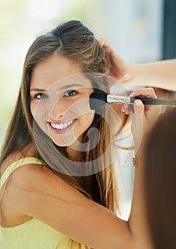 When I look my best I feel my best. Portrait of an attractive young woman applying makeup to her face with a brush.
