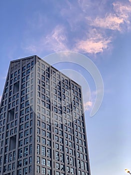 A tall office building under the purple sky