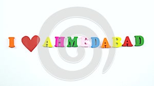 I love Ahmedabad. Text from colorful wooden letters and a beating paper red heart.