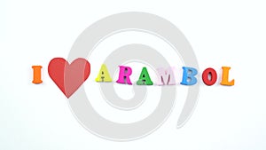I love Arambol. Text from colorful wooden letters and a beating paper red heart.