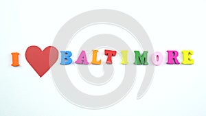 I love Baltimore. Text from colorful wooden letters and a beating paper red heart.