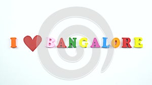 I love Bangalore. Text from colorful wooden letters and a beating paper red heart.