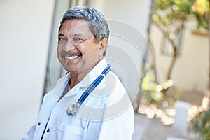 I love being a doctor. Cropped portrait of a male doctor smiling happily outside.