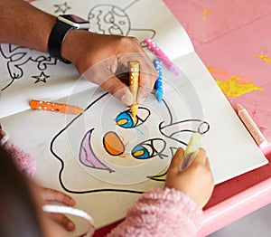 I love the bright colours. a young child completing an illustration by colouring it in.