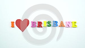 I love Brisbane. Text from colorful wooden letters and a beating paper red heart.