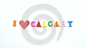 I love Calgary. Text from colorful wooden letters and a beating paper red heart.