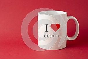 I love coffee words, inscription. White Cup with red heart. Red background with copy space