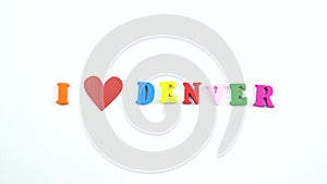 I love Denver. Text from colorful wooden letters and a beating paper red heart.