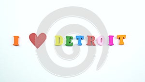 I love Detroit. Text from colorful wooden letters and a beating paper red heart.